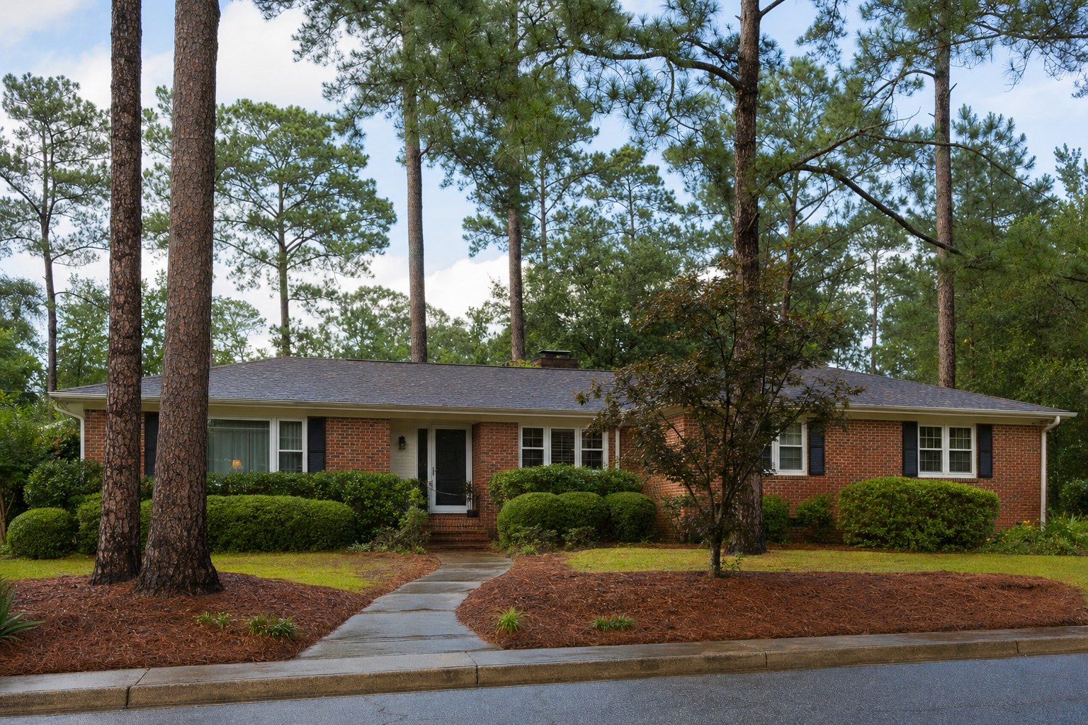 Brick ranch home with tall pines in a Martinez-style Georgia neighborhood